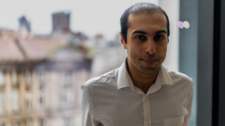 A professional headshot with the background of Birmingham City Council's Council House and Town Hall.